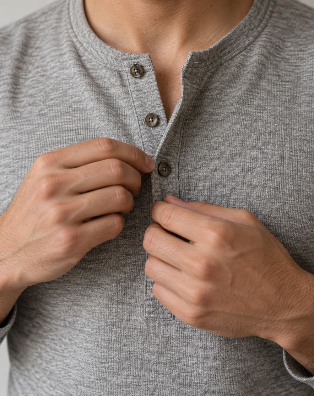 Close-up of hands checking the buttons on a shirt