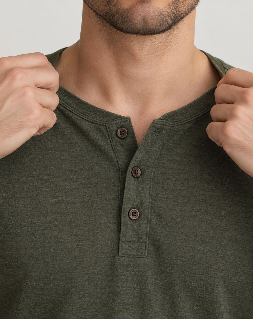 Hands stretching the collar of a knit shirt