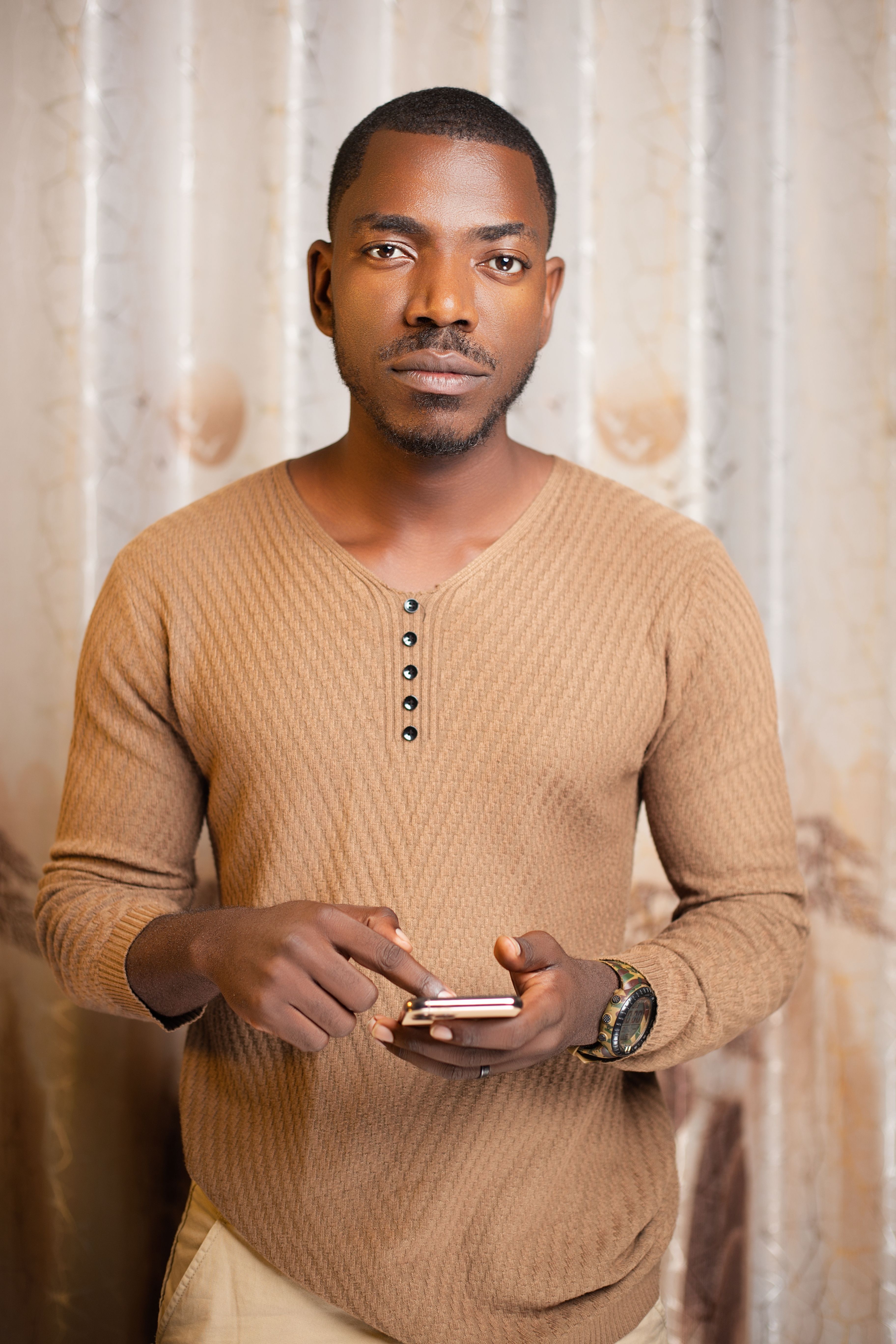 Man in a beige henley sweater, portrait