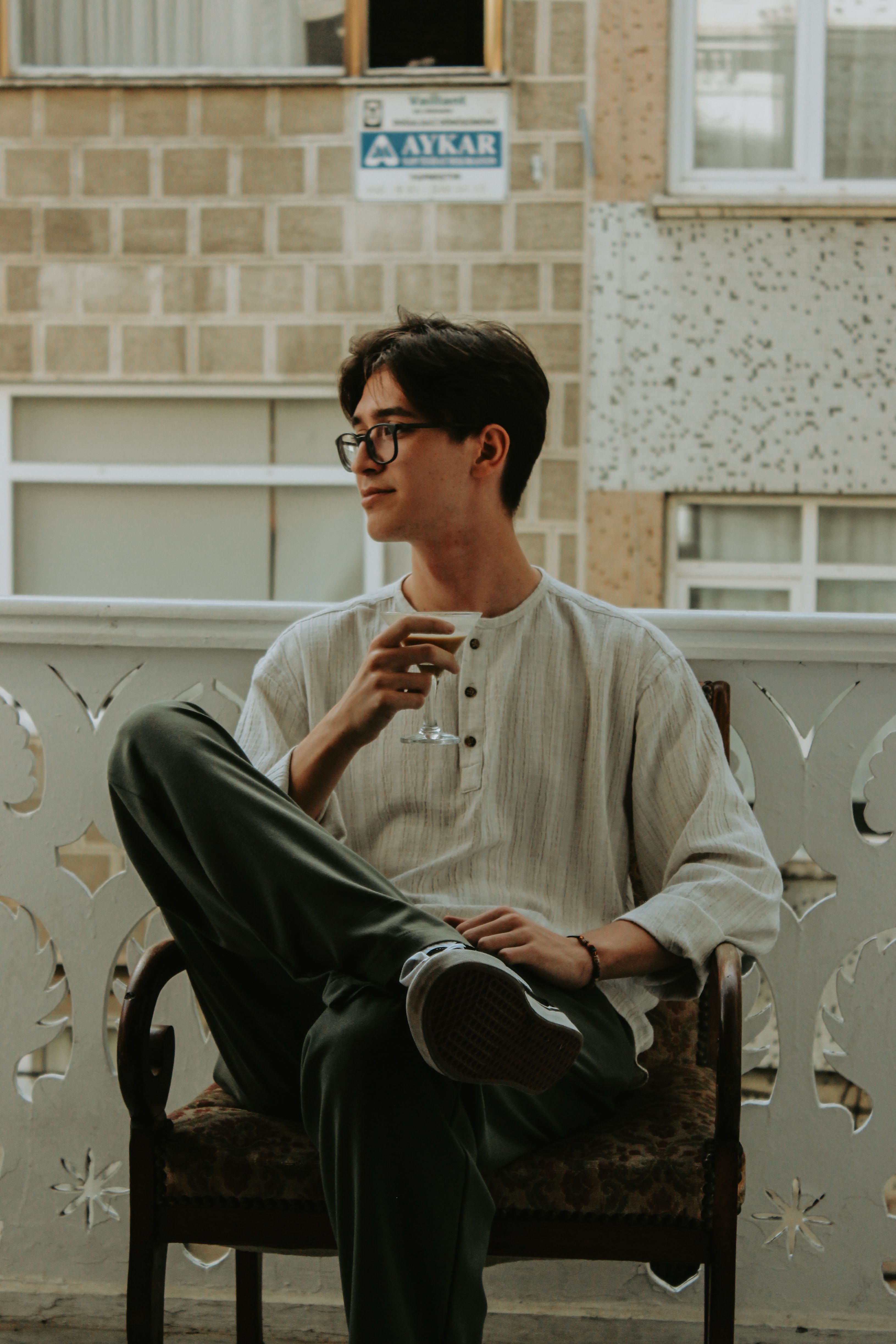 Man in a henley shirt on a cafe terrace